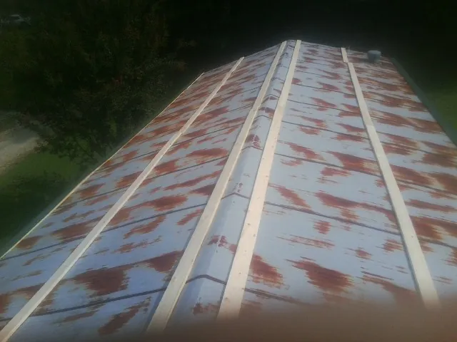 Rusted metal roof panels with new wood purlins before replacement — Storm Damage Roof Repair in Audubon by Roofing Brothers
